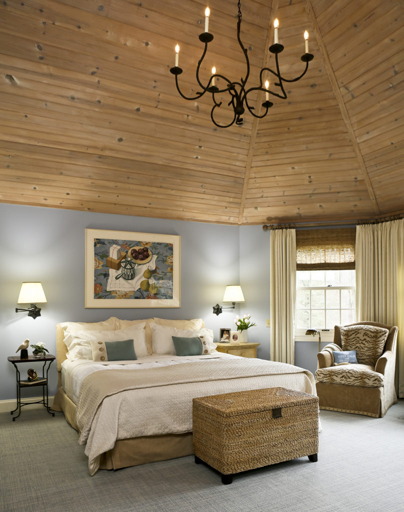 Master bedroom with blue walls and pine cathedral ceiling