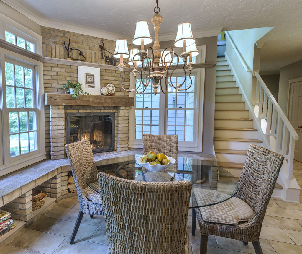 Kitchen nook with wicker chairs and fireplace