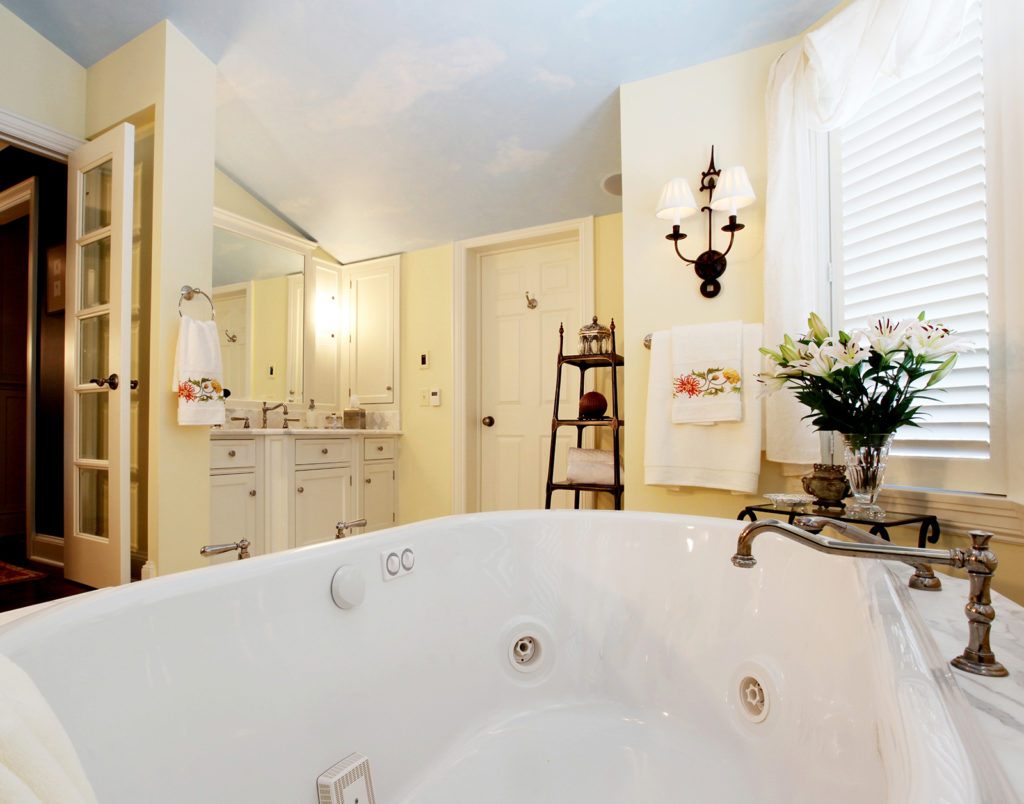 Master bath with yellow walls and sky